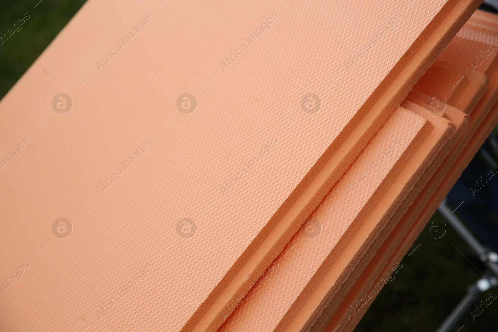 Photo of Under pool foam tiles in backyard, closeup