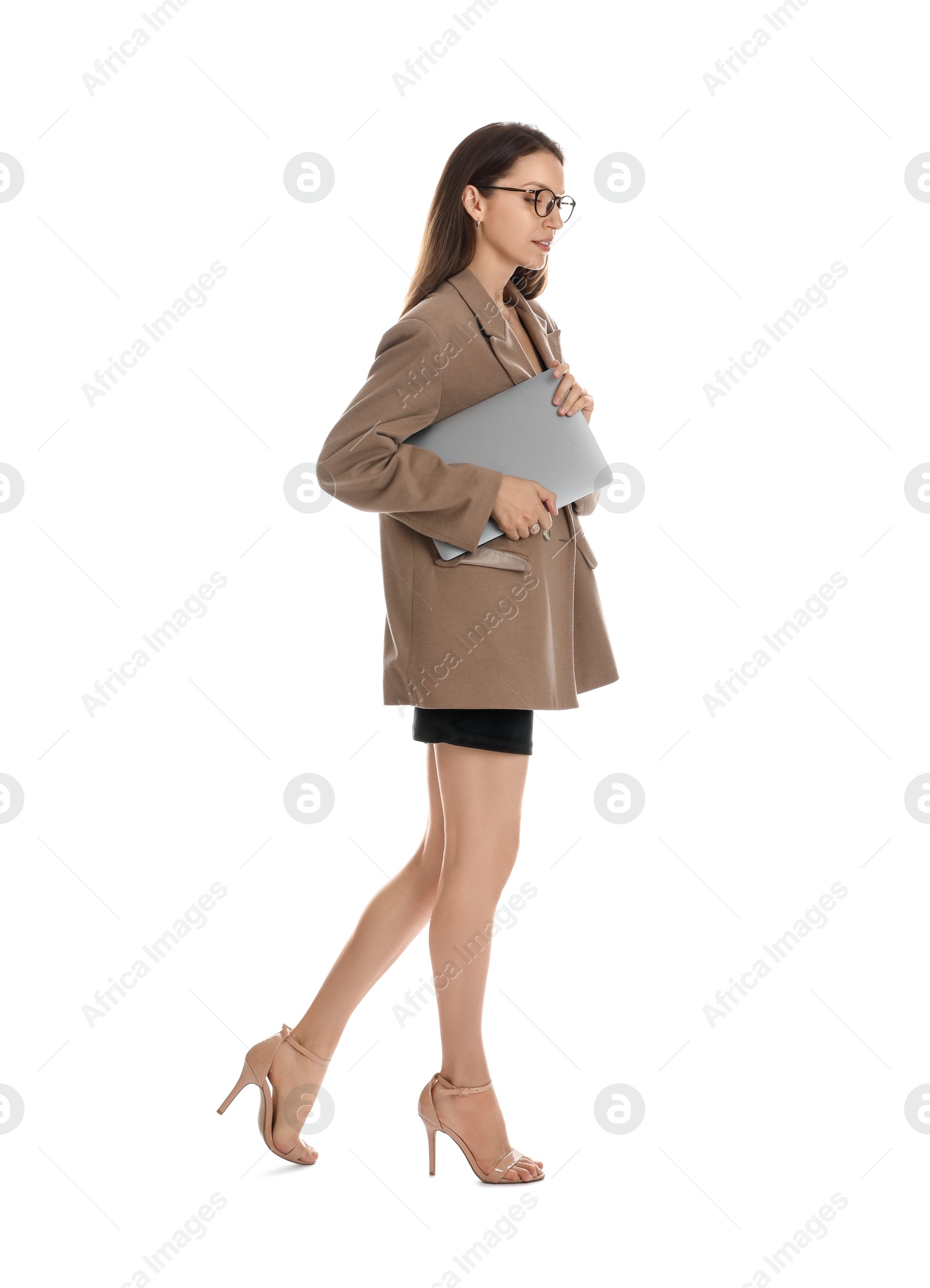 Photo of Beautiful woman in stylish brown jacket, glasses and black dress with laptop on white background