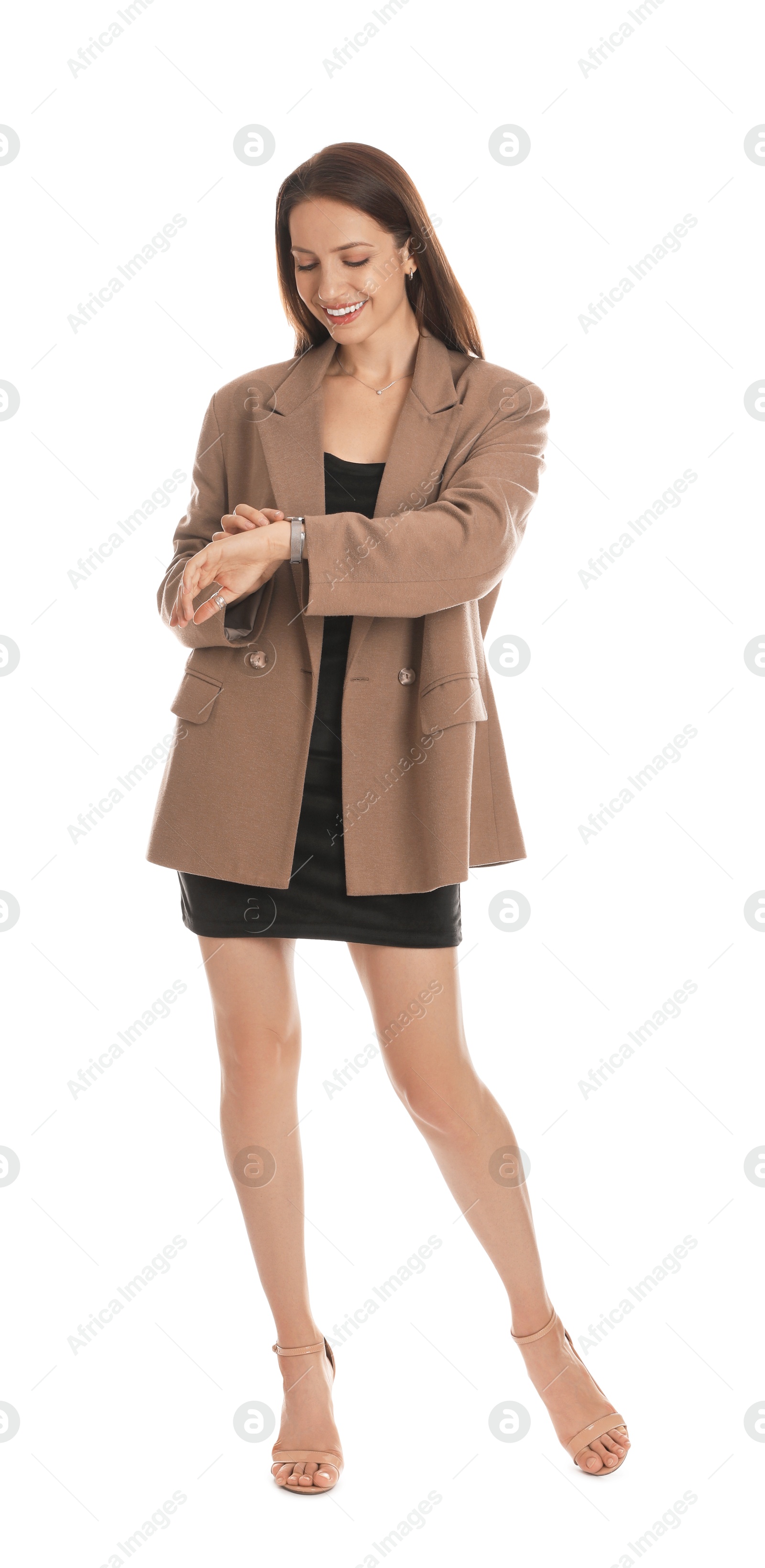 Photo of Beautiful woman in stylish brown jacket and black dress checking time on white background