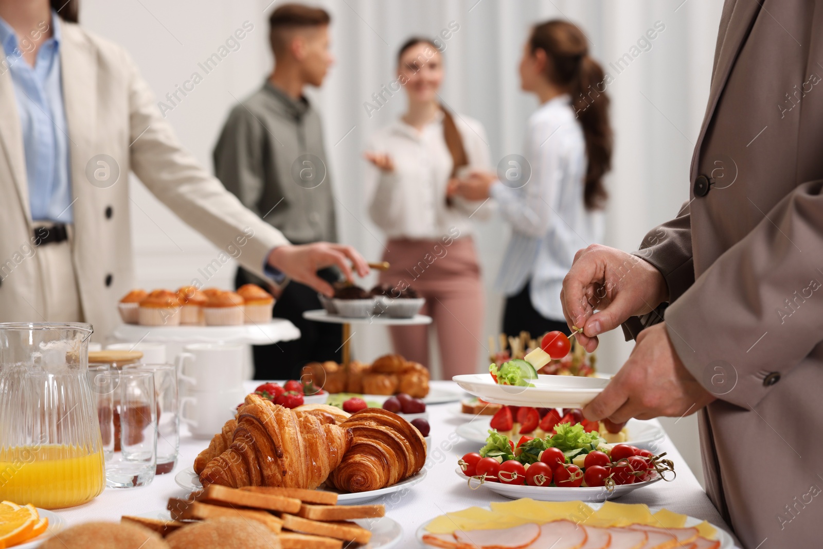 Photo of Coworkers having business lunch in restaurant, closeup