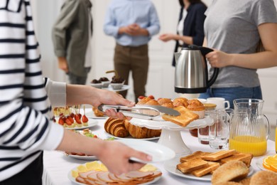 Photo of Coworkers having business lunch in restaurant, closeup