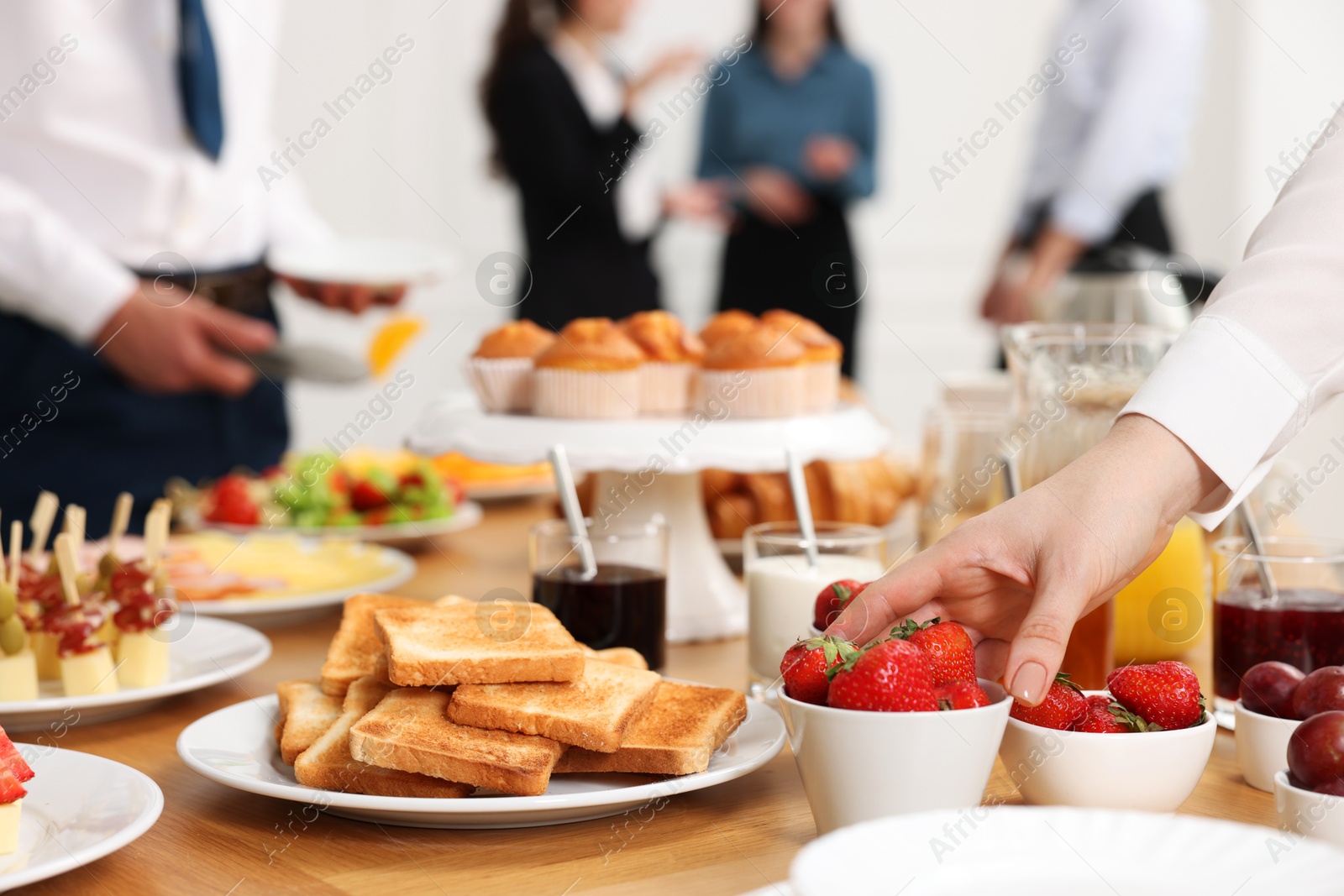 Photo of Coworkers having business lunch in restaurant, closeup