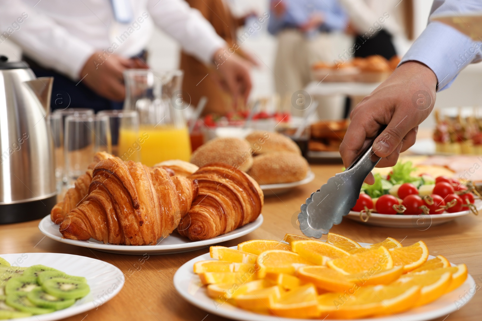 Photo of Coworkers having business lunch in restaurant, closeup