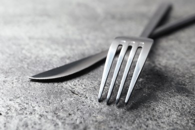 Stylish silver cutlery on grey table, closeup