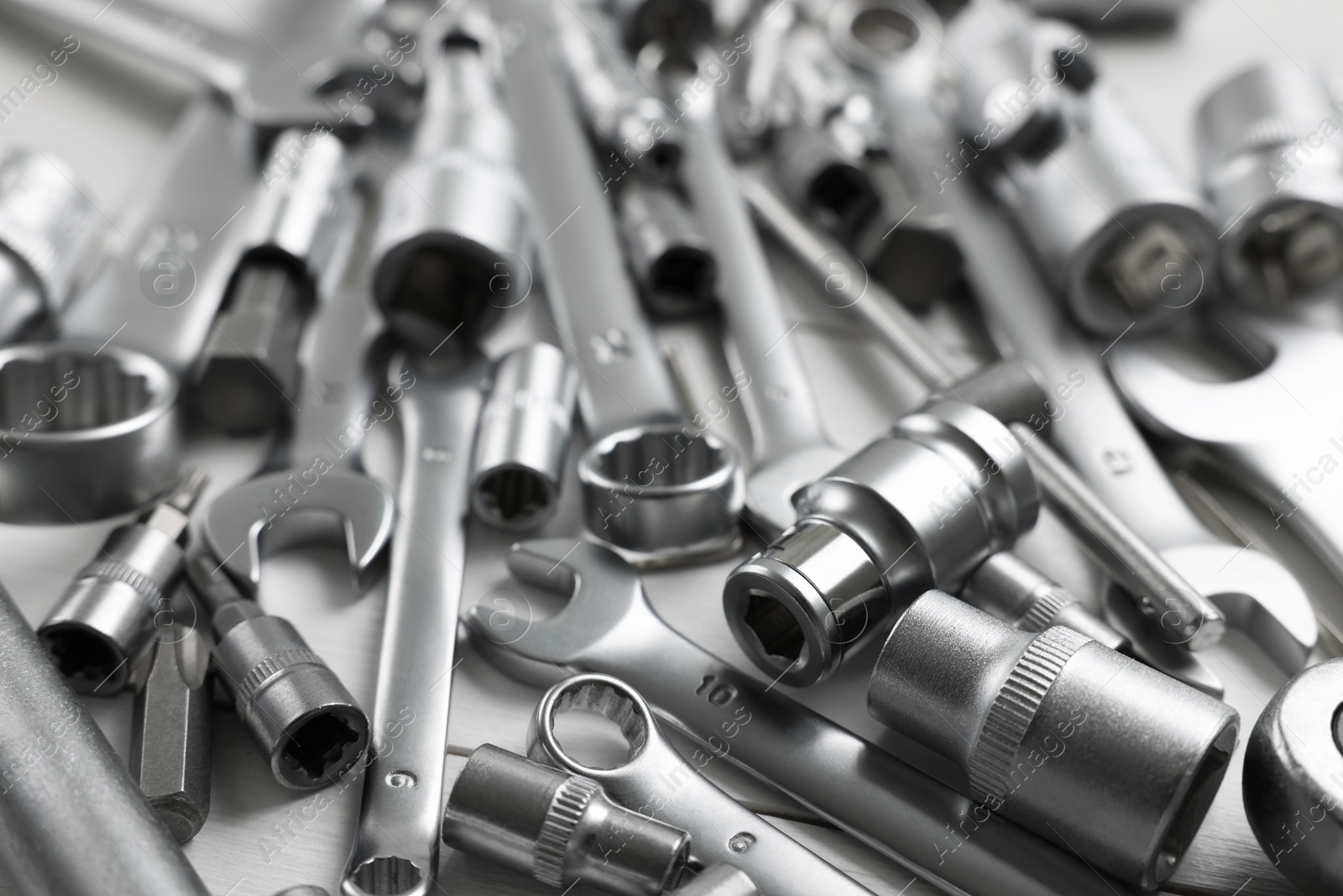 Photo of Auto mechanic's tools on white table, closeup