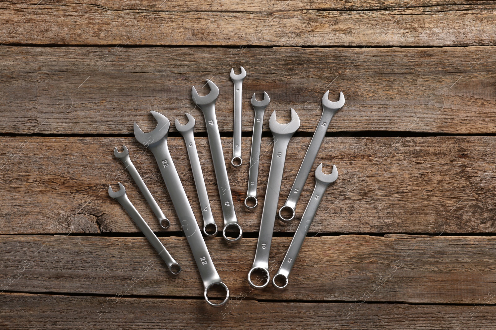 Photo of Many auto mechanic's tools on wooden table, flat lay