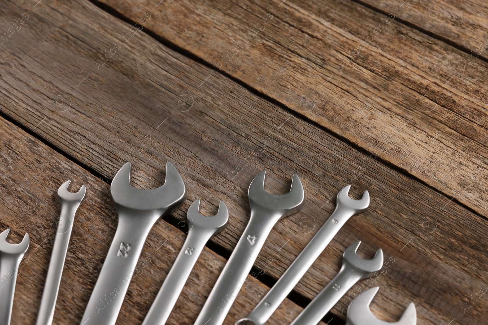 Photo of Many auto mechanic's tools on wooden table, space for text