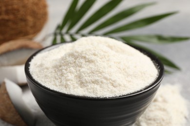 Photo of Coconut flour in bowl on table, closeup