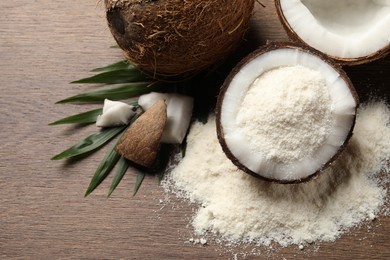 Photo of Coconut flour, fresh fruits and leaf on wooden table, flat lay