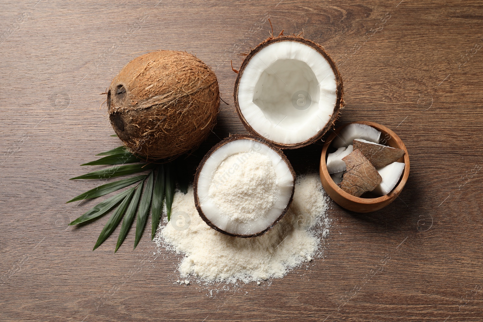 Photo of Coconut flour, fresh fruits and leaf on wooden table, flat lay