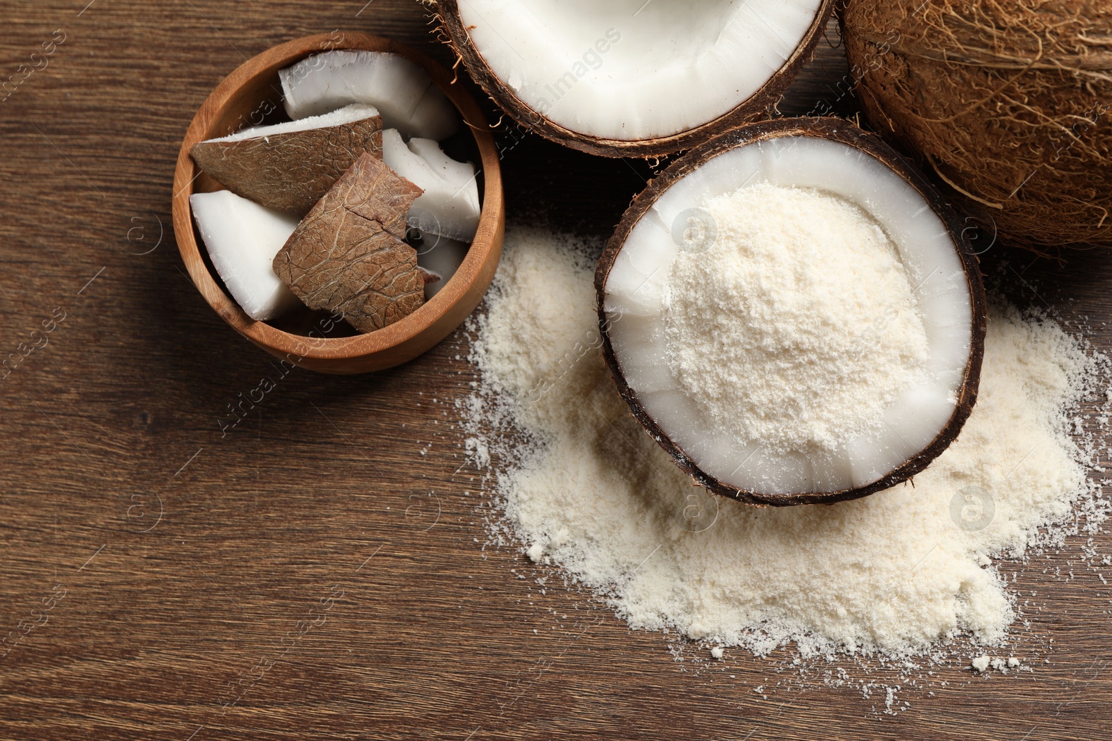 Photo of Coconut flour and fresh fruits on wooden table, flat lay