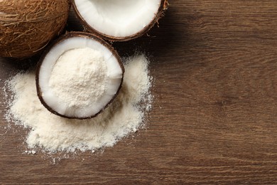 Photo of Coconut flour and fresh fruits on wooden table, flat lay. Space for text