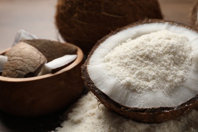 Photo of Coconut flour and fresh fruits on wooden table, closeup