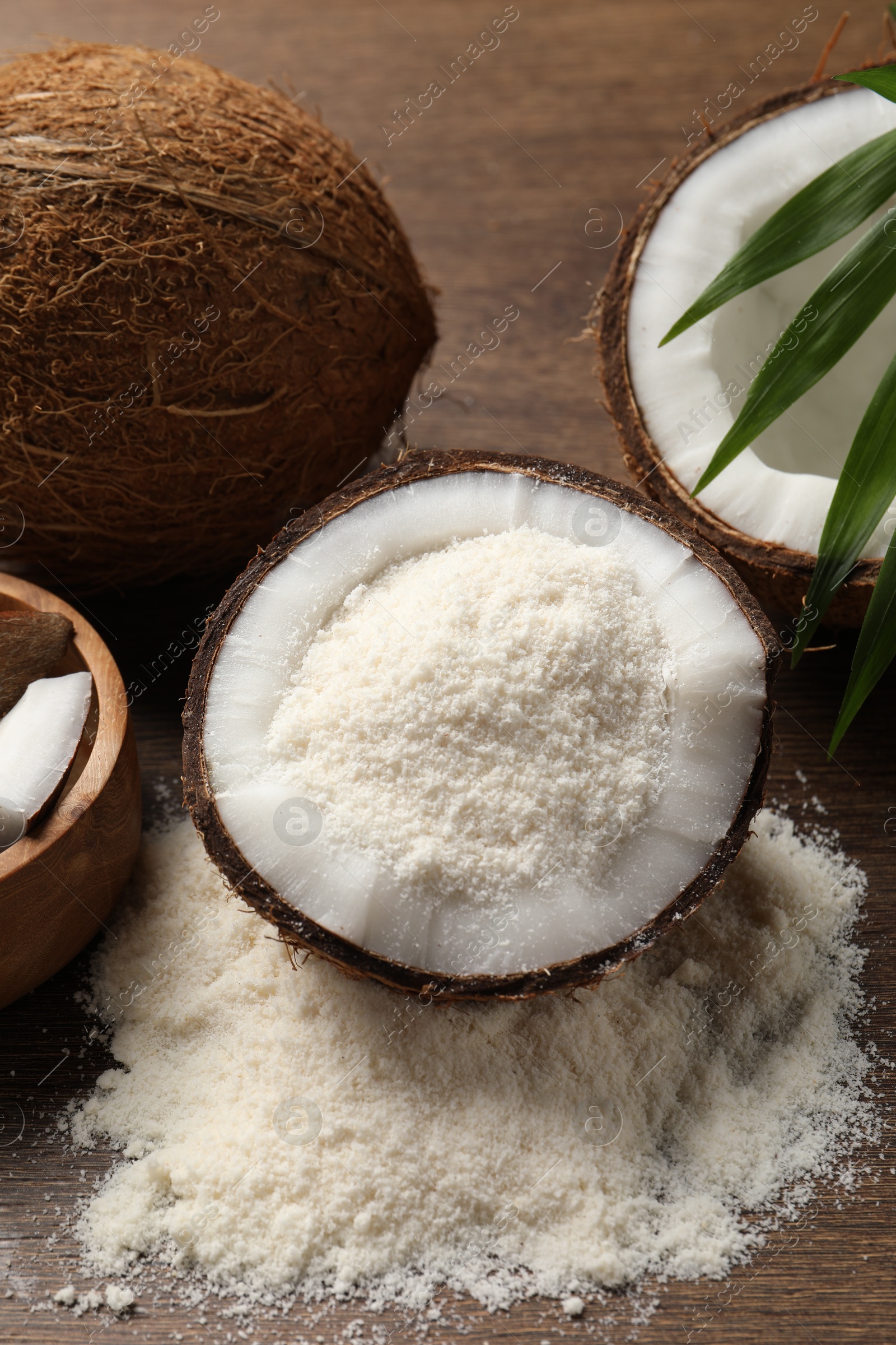 Photo of Coconut flour and fresh fruits on wooden table