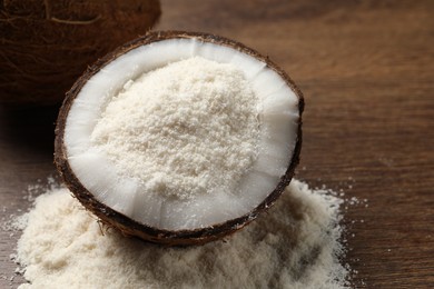 Photo of Coconut flour and fresh fruit on wooden table, closeup