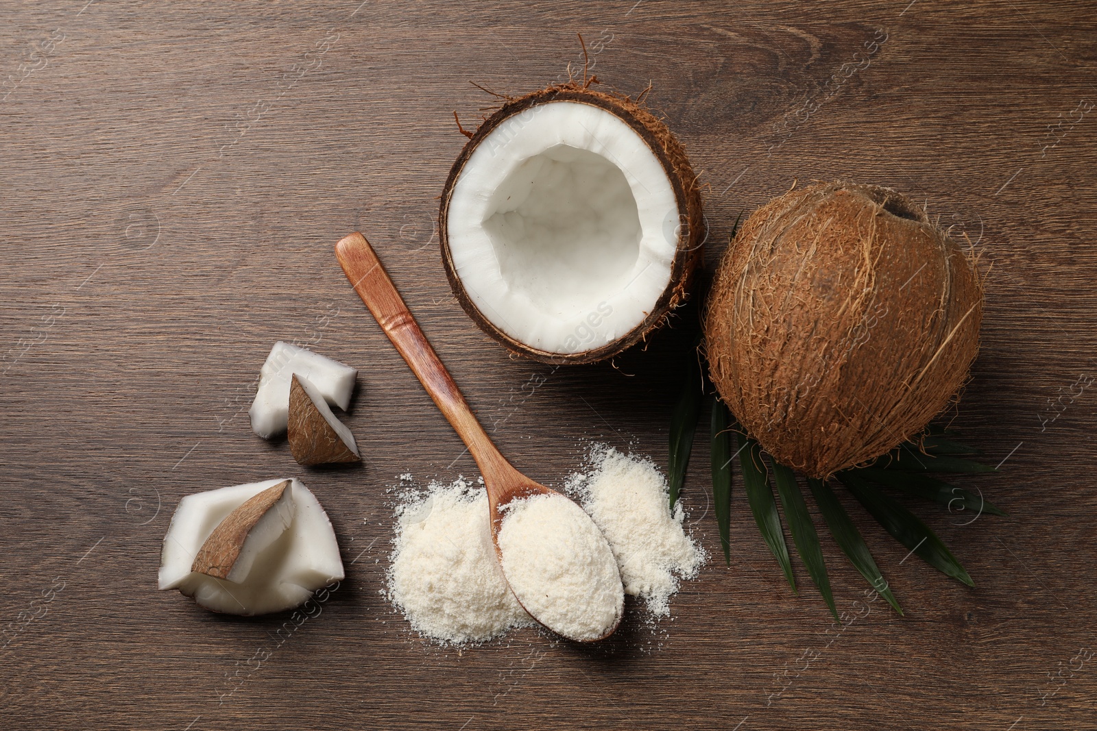 Photo of Coconut flour, fresh fruits and leaf on wooden table, flat lay