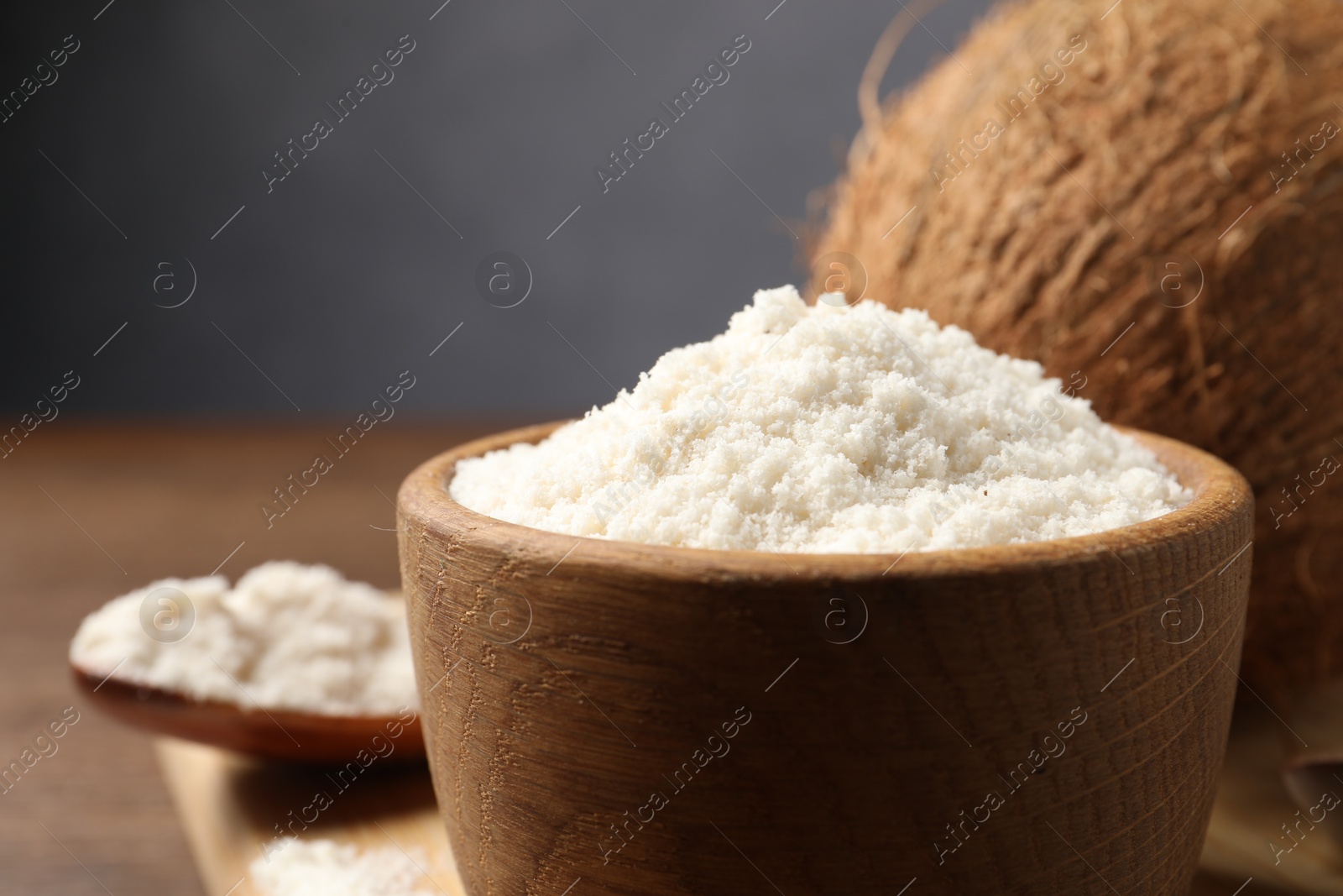 Photo of Coconut flour in bowl on table, closeup