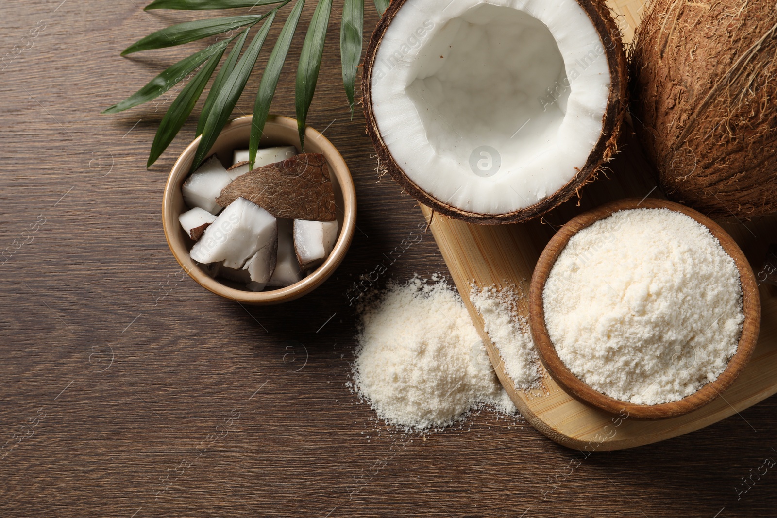 Photo of Coconut flour, fresh fruits and leaf on wooden table, flat lay