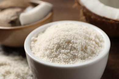 Photo of Organic coconut flour in bowl on table, closeup