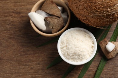 Photo of Coconut flour and fresh fruits on wooden table, flat lay. Space for text