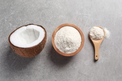 Photo of Organic coconut flour in bowl, spoon and fresh fruit on light grey table, flat lay