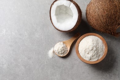 Photo of Organic coconut flour in bowl, spoon and fresh fruits on light grey table, flat lay. Space for text