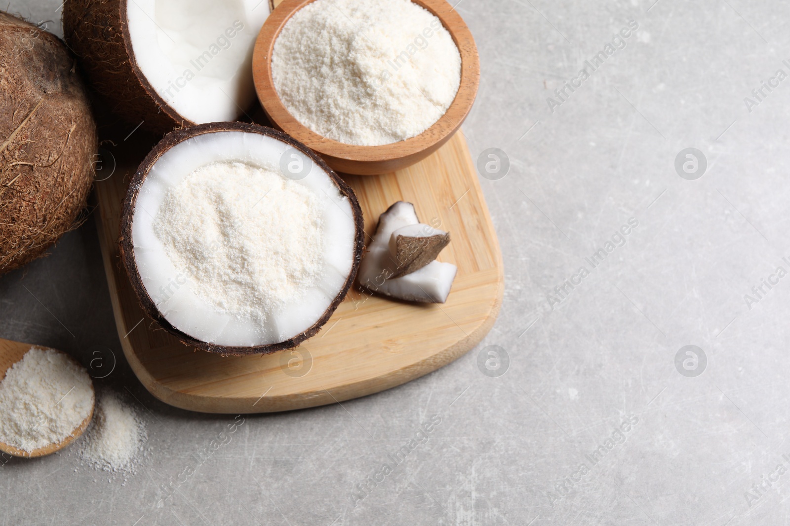 Photo of Coconut flour and fresh fruits on light grey table, above view. Space for text