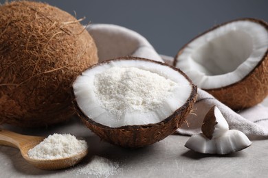 Photo of Organic coconut flour and fresh fruits on light grey table, closeup