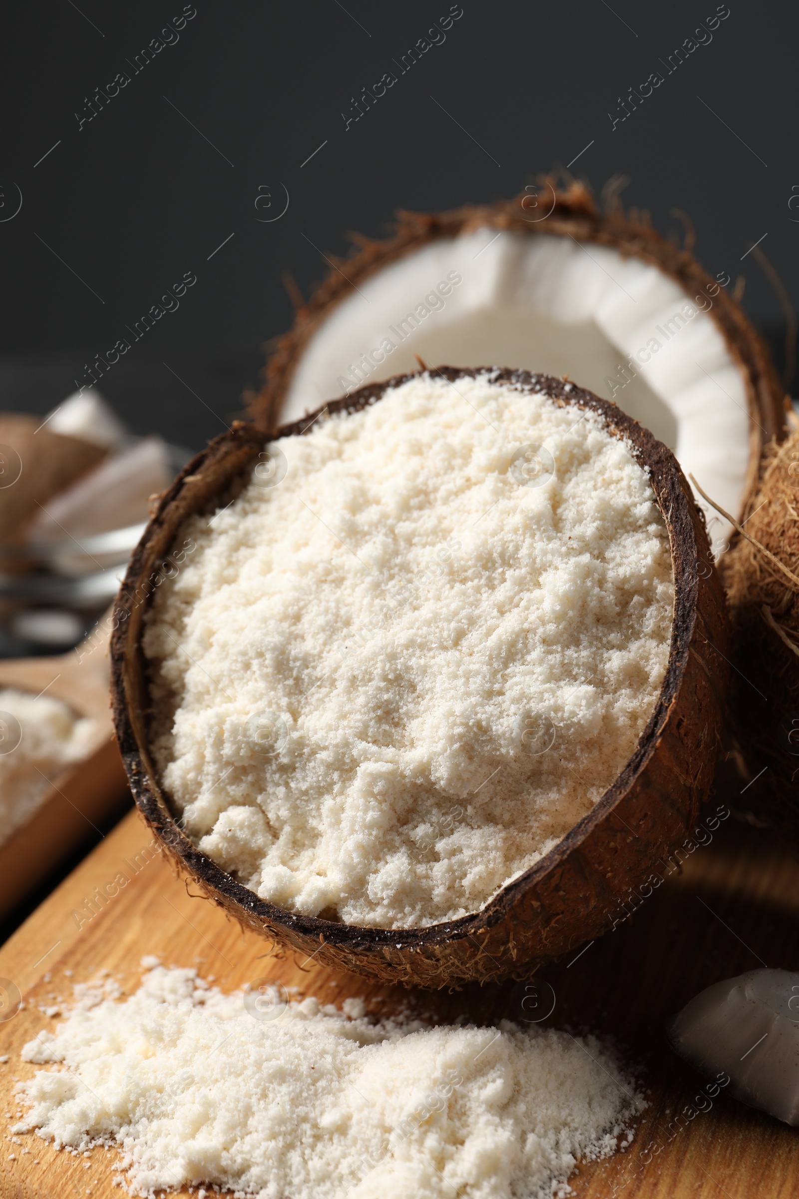 Photo of Organic coconut flour and fresh fruits on table, closeup