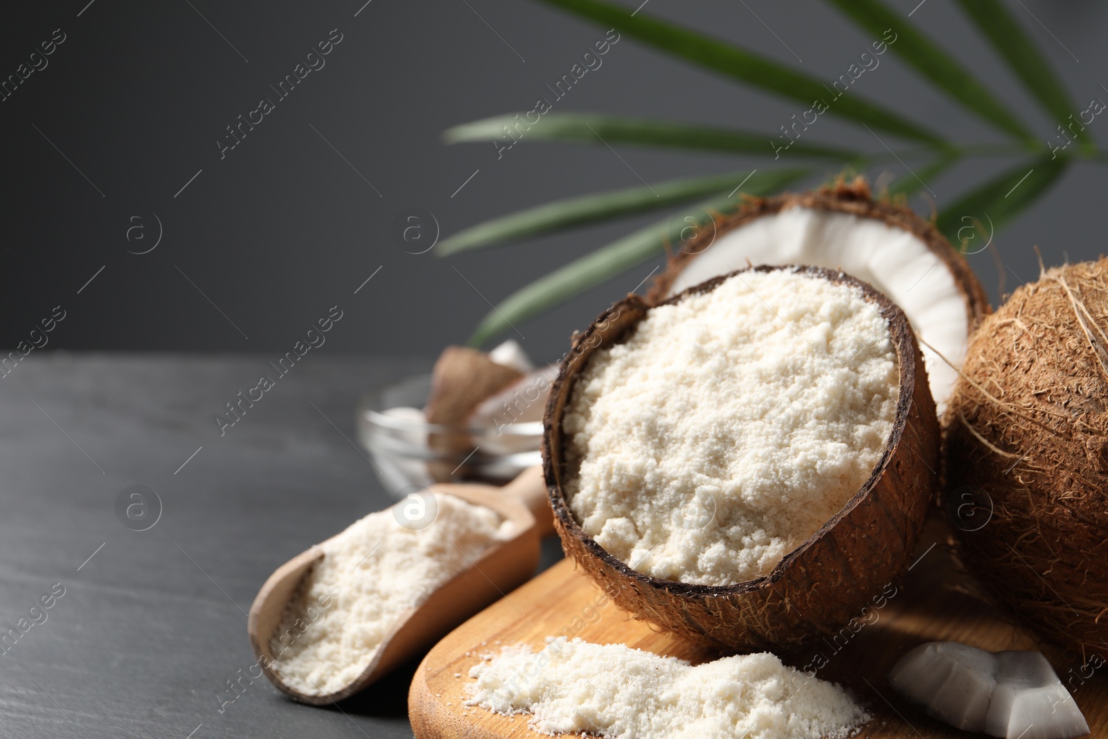 Photo of Organic coconut flour and fresh fruits on table, closeup. Space for text