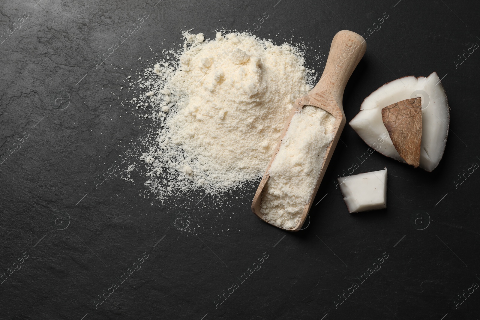 Photo of Organic coconut flour and fresh fruits on black table, flat lay. Space for text