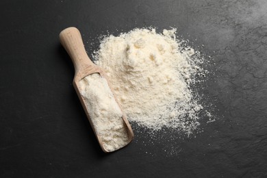 Photo of Organic coconut flour on black table, top view