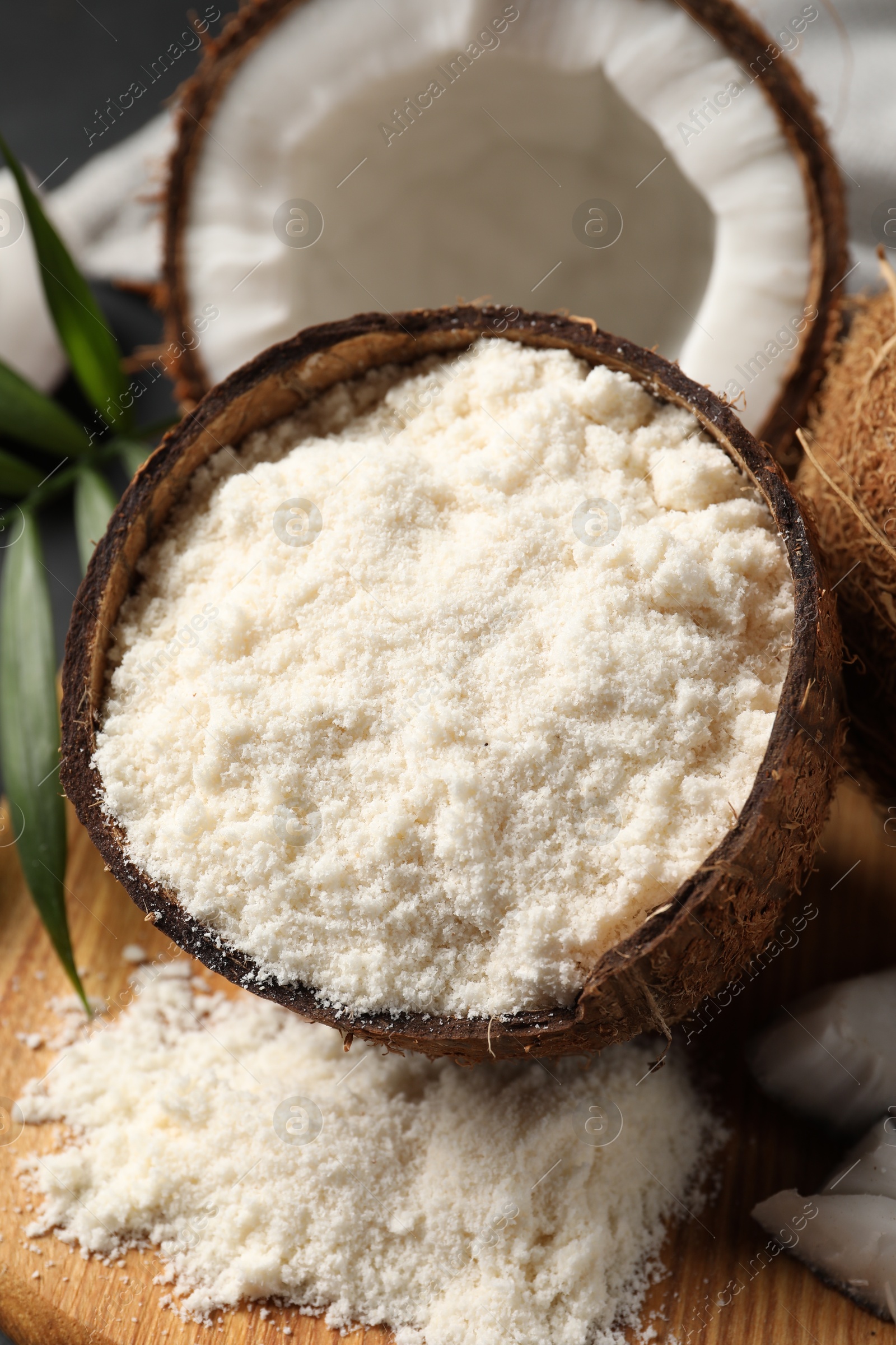 Photo of Coconut flour and fresh fruits on table, closeup