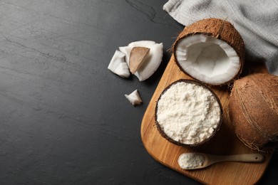 Photo of Organic coconut flour and fresh fruits on black table, flat lay. Space for text