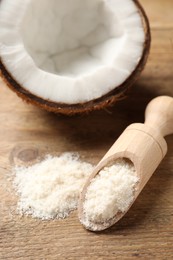 Photo of Coconut flour in scoop and fresh fruit on wooden table