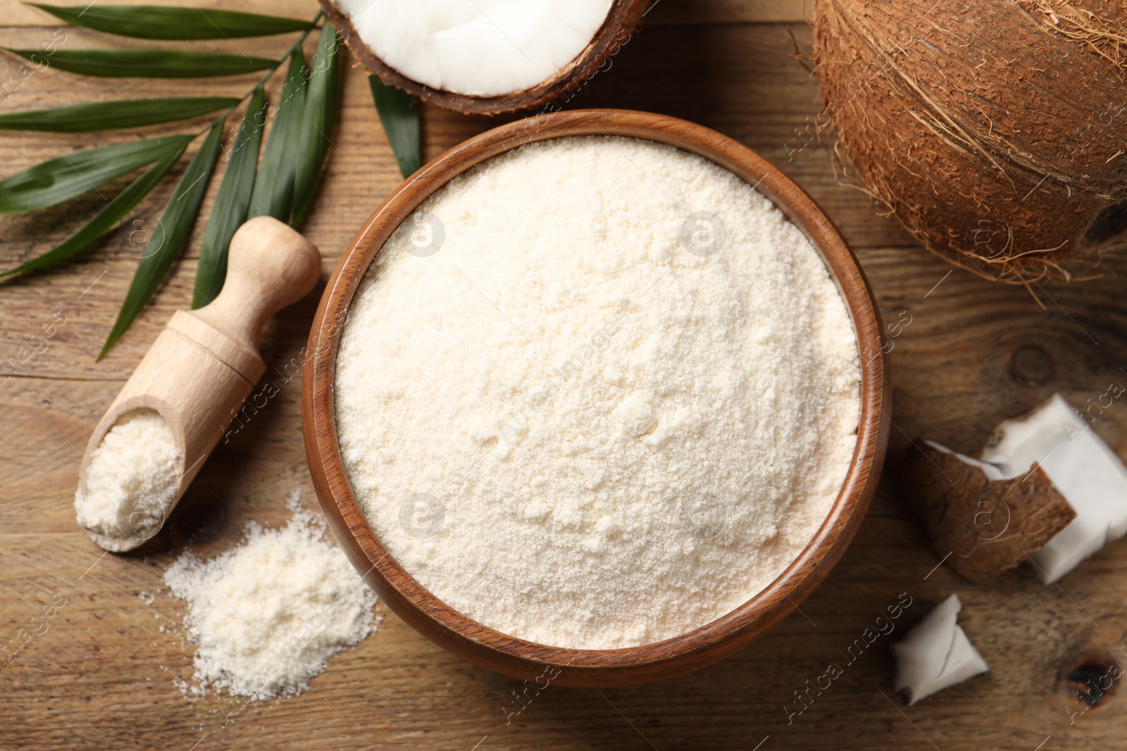 Photo of Coconut flour, fresh fruits and leaf on wooden table, flat lay