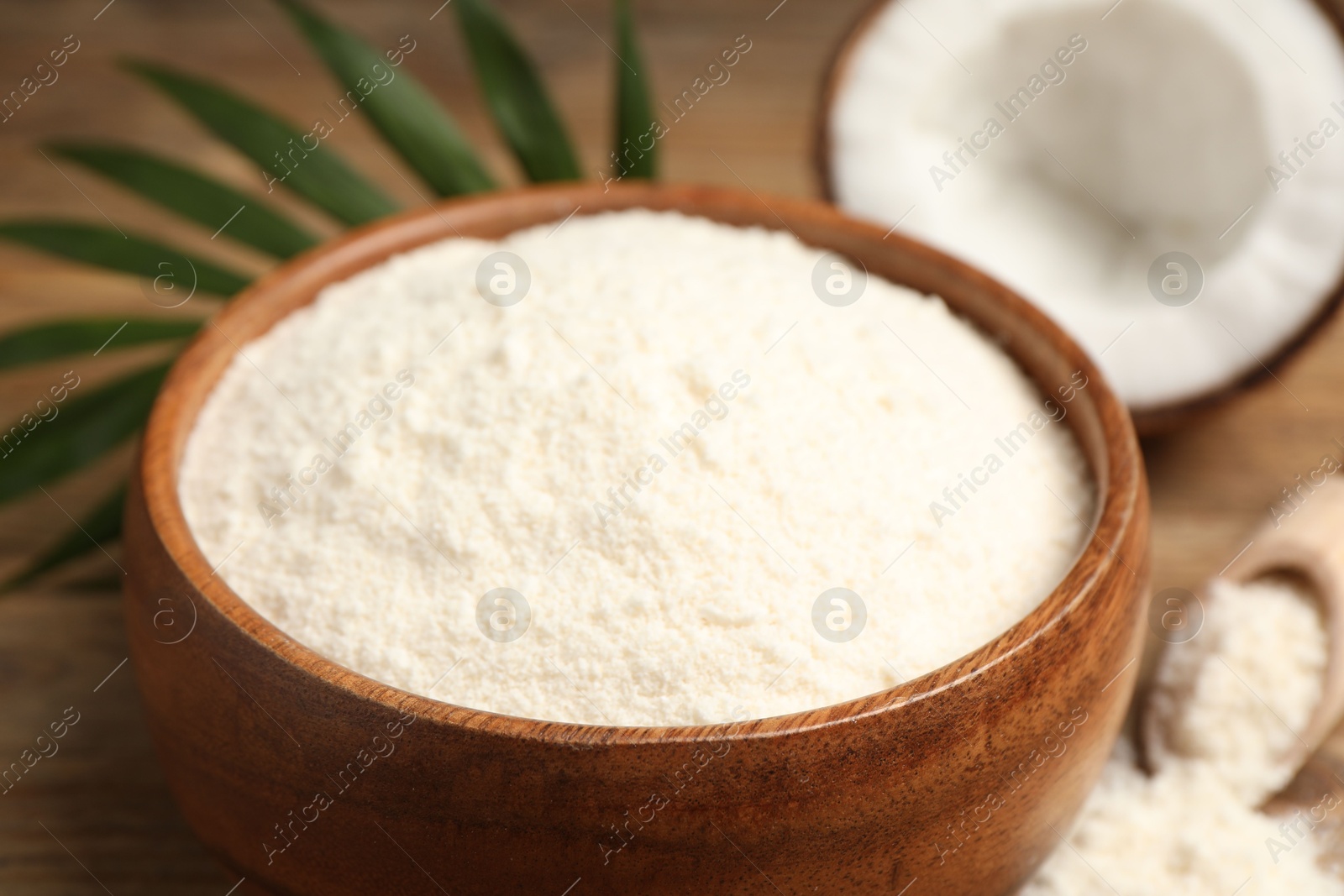 Photo of Coconut flour in bowl on table, closeup