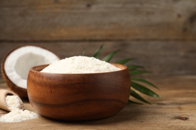 Photo of Coconut flour and fresh fruit on wooden table, closeup. Space for text