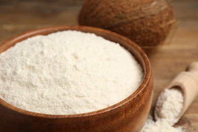 Photo of Coconut flour in bowl on table, closeup