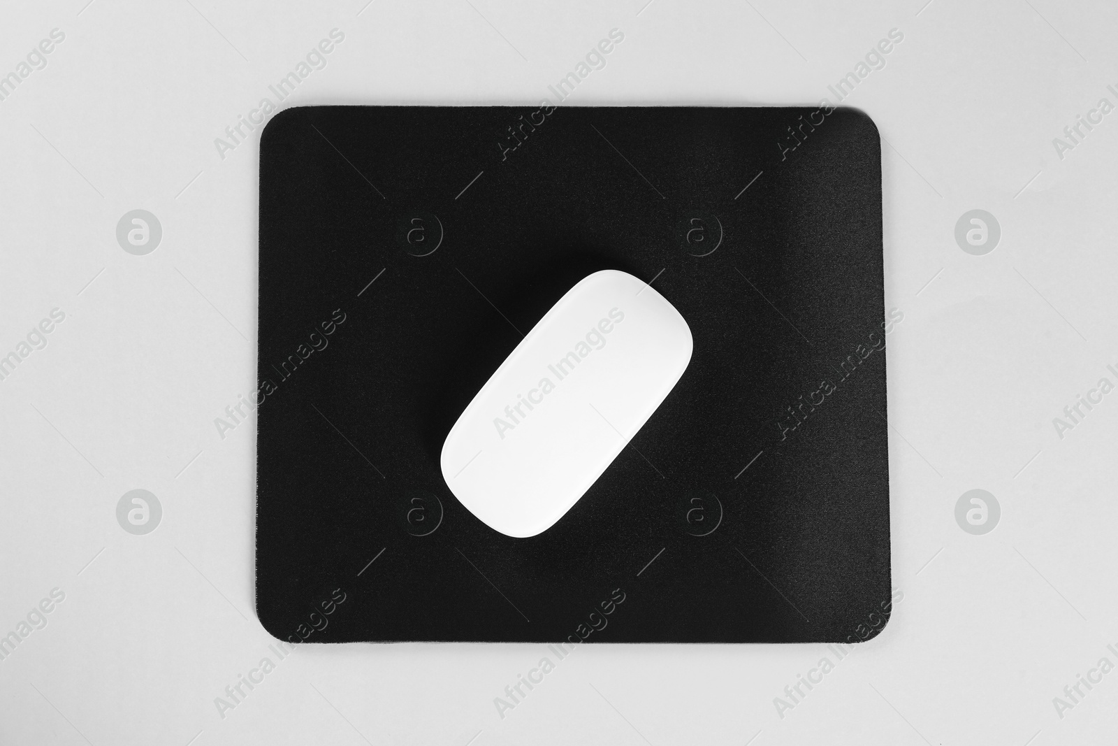 Photo of Wireless mouse and mousepad on white background, top view