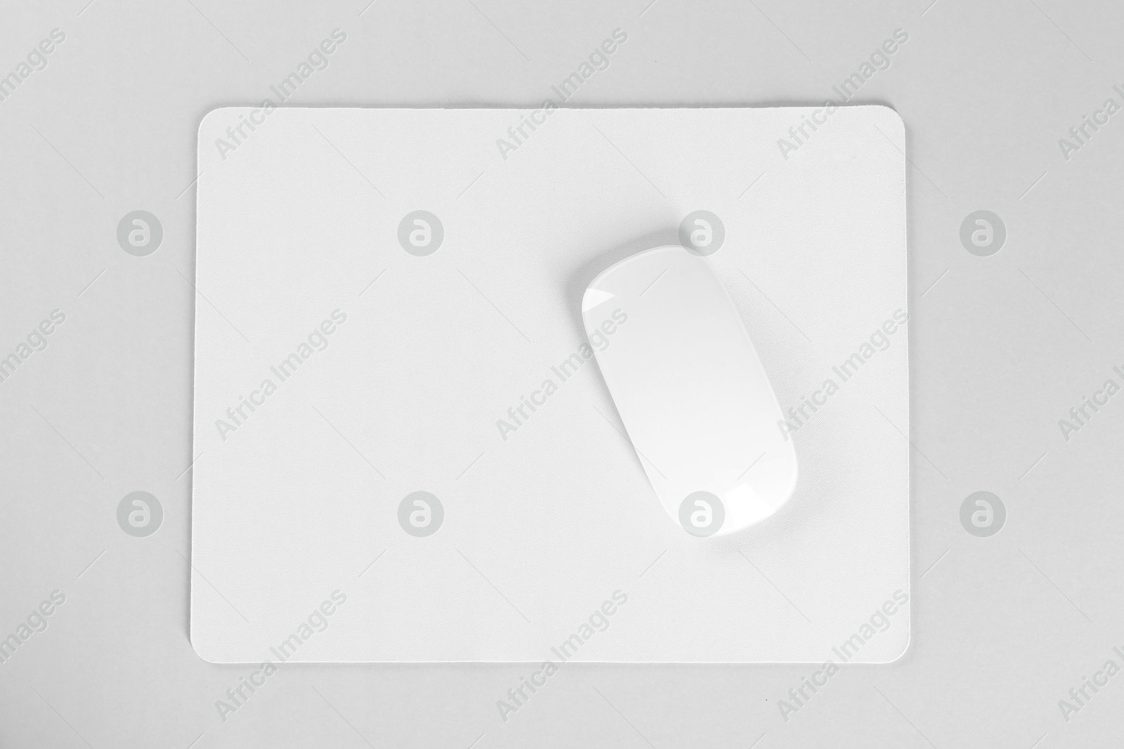 Photo of Wireless mouse and mousepad on white background, top view