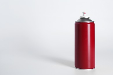 Can of spray paint on white background, space for text