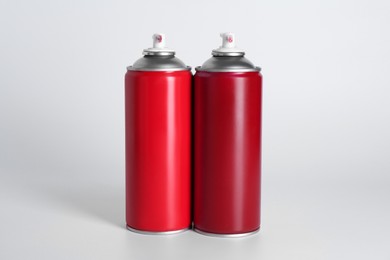 Cans of spray paint on white background