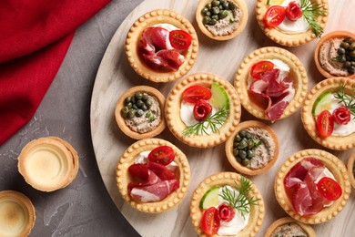 Photo of Delicious canapes on grey textured table, flat lay