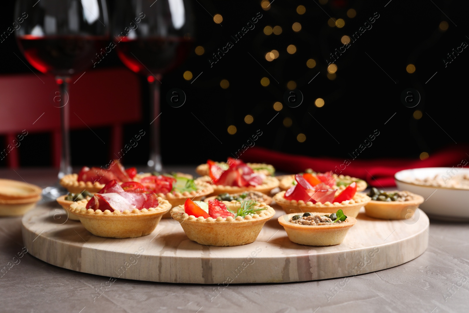 Photo of Different delicious canapes served on grey table