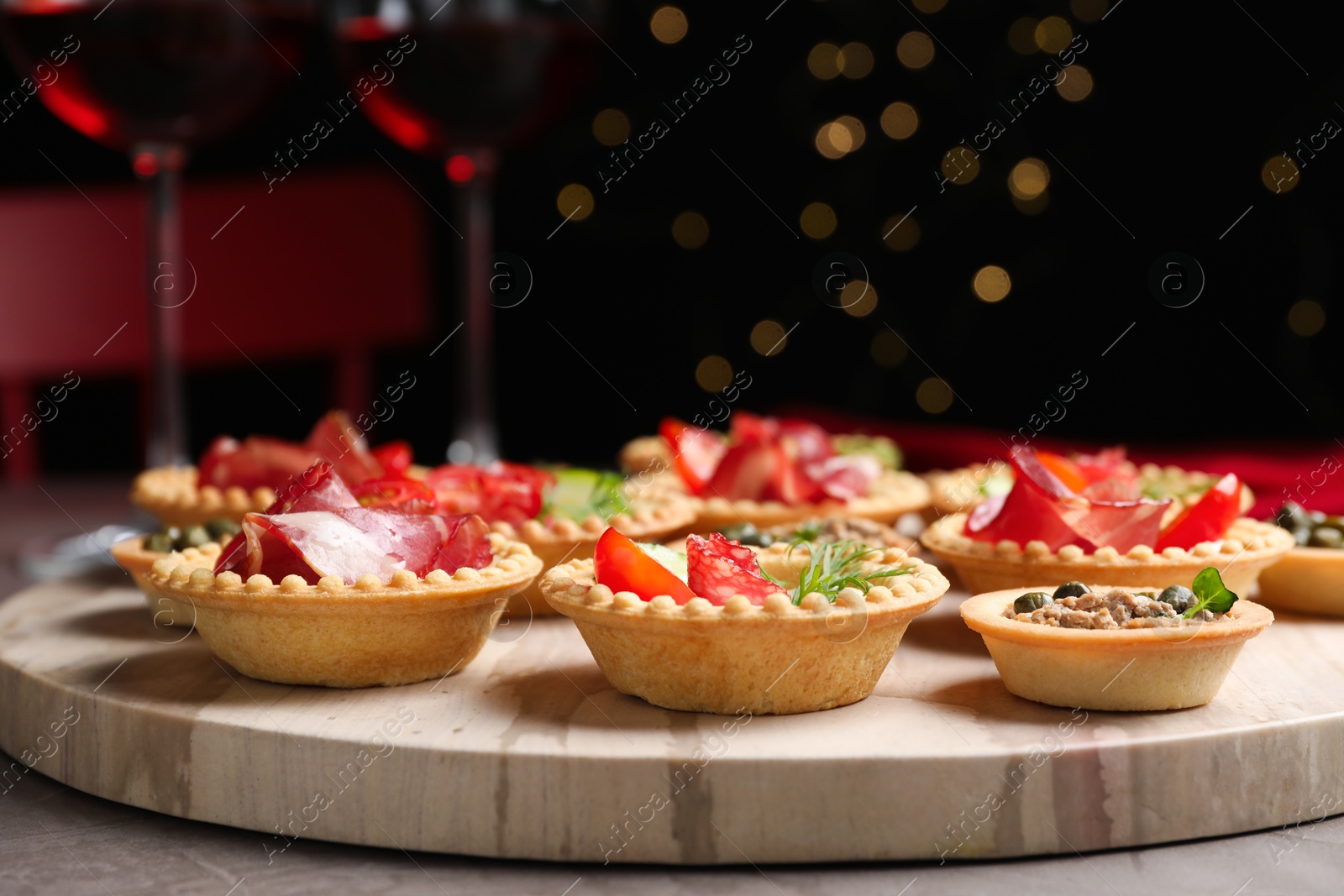 Photo of Delicious canapes with jamon and pate on grey table, closeup