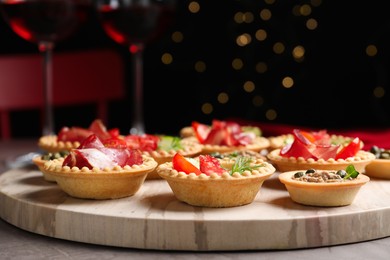 Delicious canapes with jamon and pate on grey table, closeup