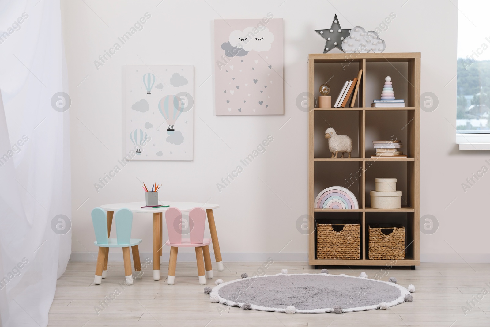 Photo of Child's room interior with modern furniture and beautiful pictures on wall