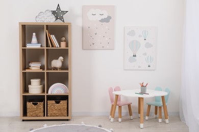 Child's room interior with modern furniture and beautiful pictures on wall