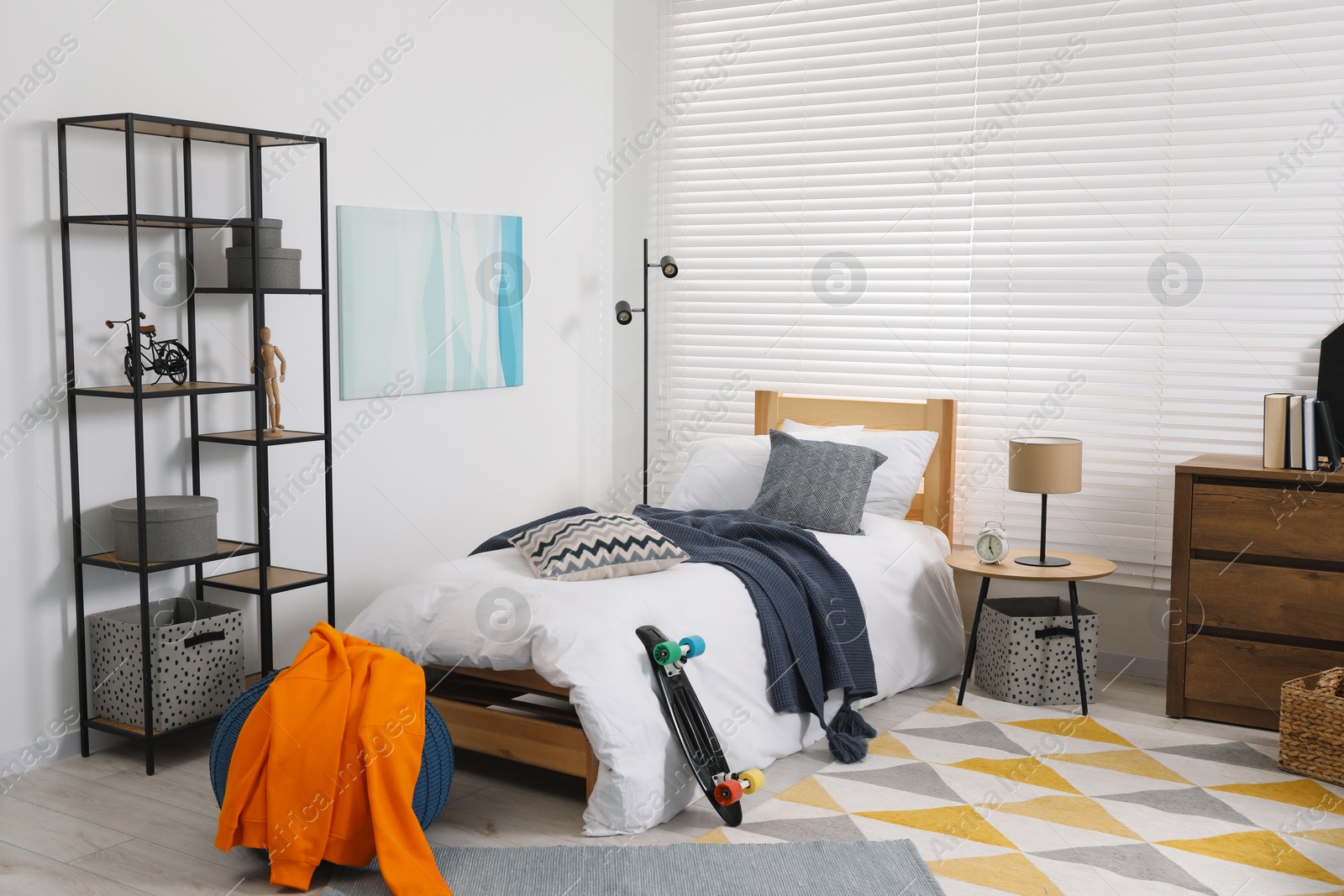 Photo of Teen's room interior with modern furniture and beautiful picture on wall